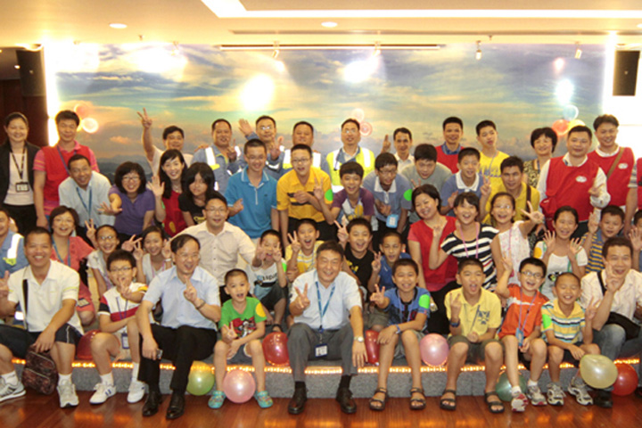 Jiang Yansheng (first row, fifth from left), Assistant Managing Director of YICT, takes a picture with the children and some staff members