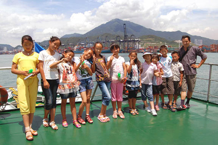 The visiting children and their teacher on board a cruise ship at Yantian Port