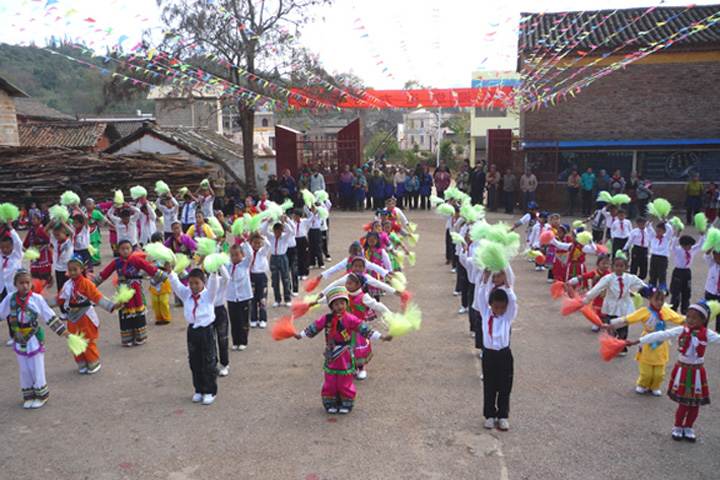 Children welcome visitors from YICT with dance