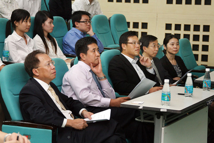 The panel of judges listening attentively to the presentations