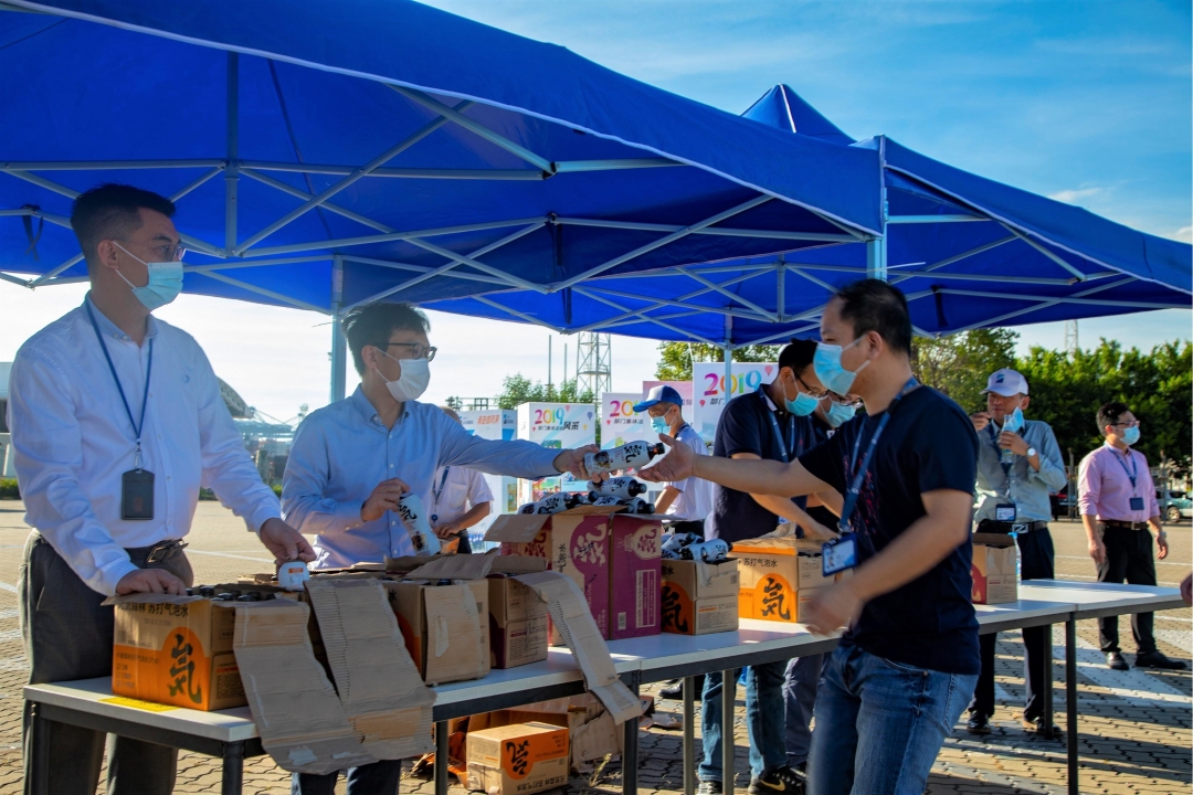 The management giving out fruit and drink to staff